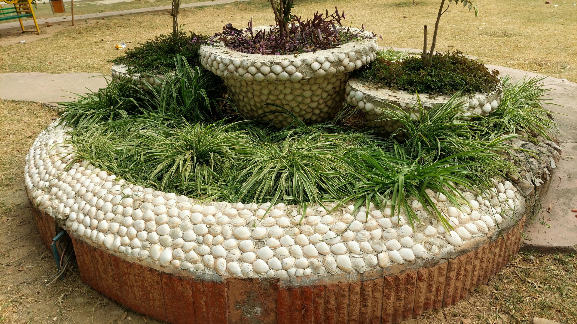 A stunning and unique plant bed design tailored for gardening enthusiasts, featuring creative shapes, layered arrangements, and a mix of colorful flowers and greenery